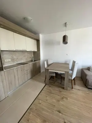 a kitchen and dining room with a table and a couch at Aivazovski park - Pomorie SP apartments in Pomorie