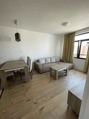 a living room with a couch and a table at Aivazovski park - Pomorie SP apartments in Pomorie