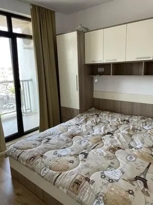 a large bed in a room with a large window at Aivazovski park - Pomorie SP apartments in Pomorie
