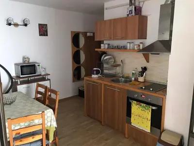 a kitchen with a sink and a stove top oven at Апартамент Хармония in Sozopol