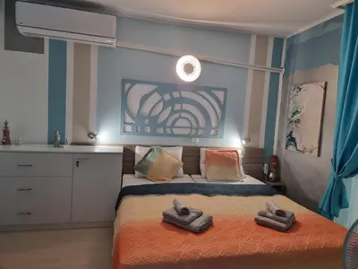 a bedroom with a bed with towels on it at Апартамент BLUE SUMMER - уют, близо до морето in Burgas City