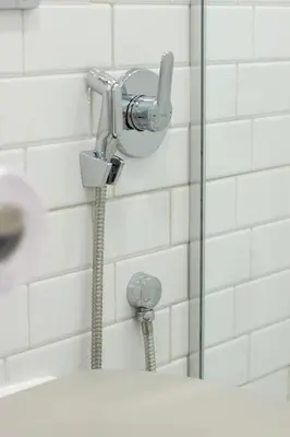a shower in a bathroom with a hose at COZZIE by RV Apartments in Varna City