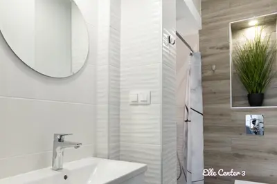 a white bathroom with a sink and a mirror at Elle Center by RV Apartments - TOP center in Varna City