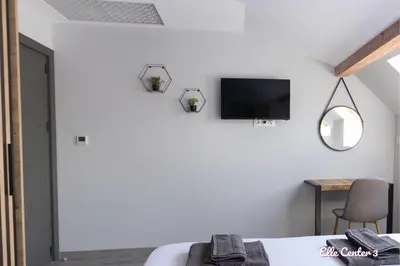 a bedroom with a bed and a tv on the wall at Elle Center by RV Apartments - TOP center in Varna City