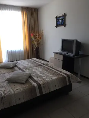 a bedroom with a bed and a tv on a desk at Sunny Gardens in Sunny Beach