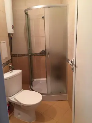 a bathroom with a toilet and a glass shower at Sunny Gardens in Sunny Beach