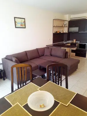 a living room with a couch and a table and chairs at Sunny Gardens in Sunny Beach
