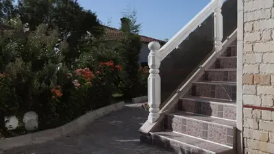a set of stairs leading up to a house at Къща за гости АЛЛА in Byala