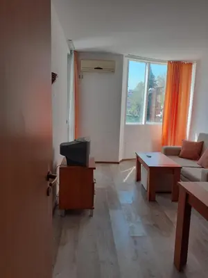 a living room with a couch and a table at Апартамент Полюси 2 in Sunny Beach