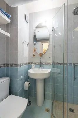 a bathroom with a sink and a glass shower at Solero in Pomorie