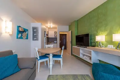 a living room with a couch and a table with chairs at Solero in Pomorie