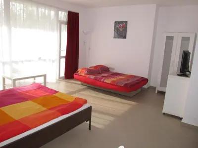 a bedroom with two beds and a flat screen tv at Apartments and studios in Cote d’Azure in Sunny Beach