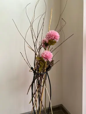 a vase filled with pink flowers and branches at Apartment Starfish in Varna City