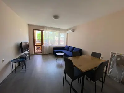 a living room with a blue couch and a table at Apartment Starfish in Varna City