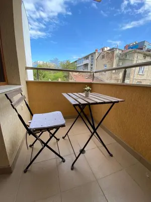 a table and a chair sitting on a balcony at Apartment Starfish in Varna City