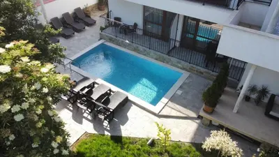 an overhead view of a swimming pool next to a building at Апартамент 