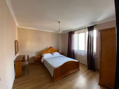 a bedroom with a large bed and a window at Апартамент 