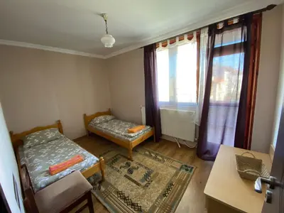a small room with a bed and a window at Апартамент 