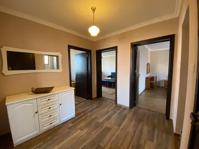 a living room with a white dresser and a television at Апартамент 