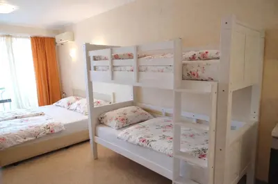 two white bunk beds in a room at One bedroom guest suite in Sunny Beach