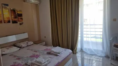 a bedroom with a bed and a large window at Luxsus Apartment Diamond Sveti Vlas in Sveti Vlas