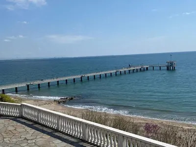 a pier in the water next to a beach at Markoni 4 in Burgas City
