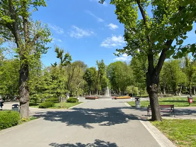 a park with a bench and trees on a street at Markoni 4 in Burgas City