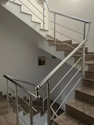 a metal railing in a staircase with white walls at Къща за гости Деневи in Primorsko