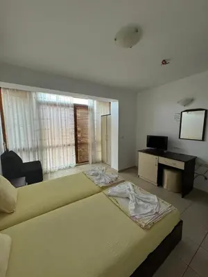 a large bedroom with a large bed in a room at Къща за гости Деневи in Primorsko