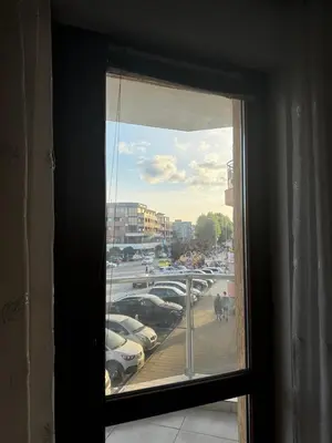 a window view of a parking lot with cars parked at Къща за гости Деневи in Primorsko