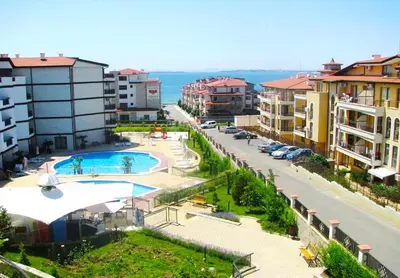 an aerial view of a city with a pool and buildings at Александър Студио in Sveti Vlas