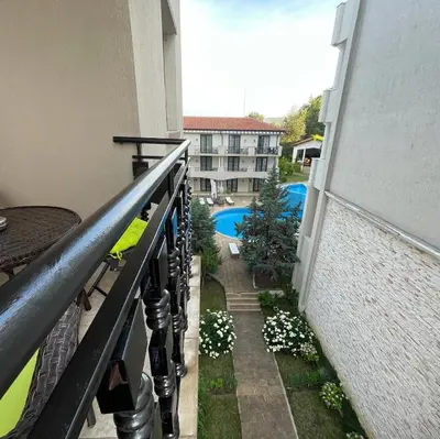 a balcony with a view of a swimming pool at Apartament in The Cliff Beach & Spa **** in Obzor