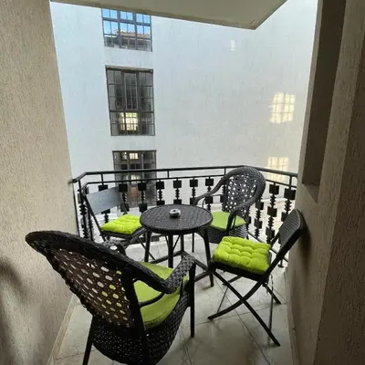 a balcony with chairs and a table on a balcony at Apartament in The Cliff Beach & Spa **** in Obzor