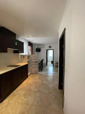 an empty kitchen with a counter and a table at Apartament in The Cliff Beach & Spa **** in Obzor