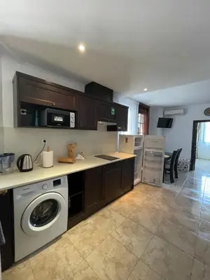 a kitchen with a washer and dryer in a room at Apartament in The Cliff Beach & Spa **** in Obzor