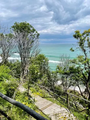 a stairway to the beach with the ocean in the background at Apartament in The Cliff Beach & Spa **** in Obzor