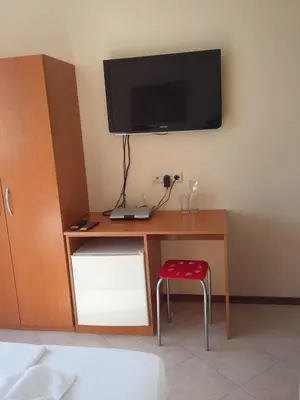 a room with a desk with a television on a wall at Къща за гости Кая in Sozopol