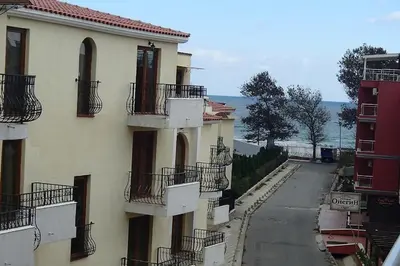 a building with balconies on the side of a street at Sozopol Apartcomplex Onegin 2,free parking in Sozopol