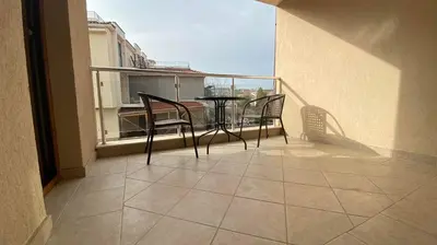 a balcony with a table and chairs on a balcony at Sozopol Apartcomplex Onegin 2,free parking in Sozopol