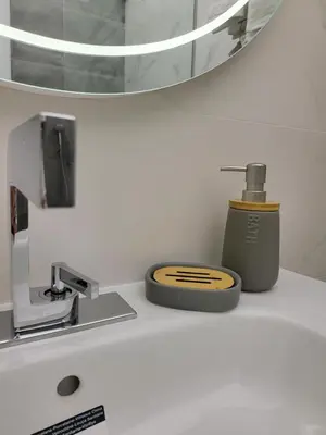 a bathroom counter with a soap dispenser and a sink at AMAYA in Varna City