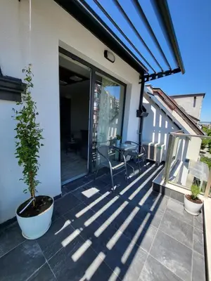a patio with a table and chairs on a house at AMAYA in Varna City