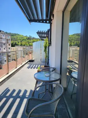 a patio with a table and chairs on a balcony at AMAYA in Varna City