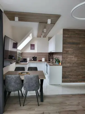a kitchen and dining room with a table and chairs at AMAYA in Varna City