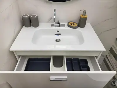 a white sink in a white bathroom with two speakers at AMAYA in Varna City