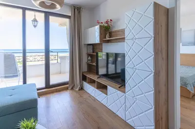 a living room with a view of the ocean at Smokini Beach Apartment in Sozopol