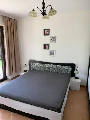 a bedroom with a large bed in a room at Апартамент Silver Star in Sozopol
