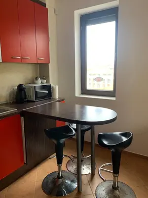 a kitchen with a table and two bar stools at Апартамент Silver Star in Sozopol