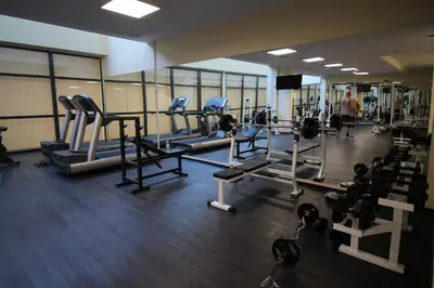 a gym with tread machines and a man in the background at PARADISO 'B' 605 Private Apartment Nessebar in Nesebar