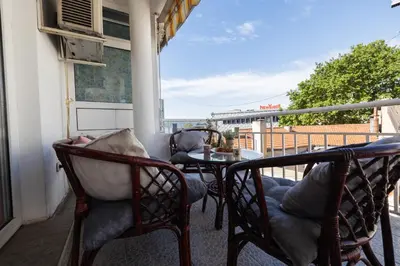 a balcony with chairs and a table on a balcony at Promenade Rooftop Flat in Varna City