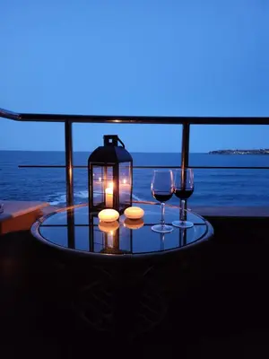 a table with two wine glasses and a lantern at Sozopol Bulgaria VIP zona in Sozopol